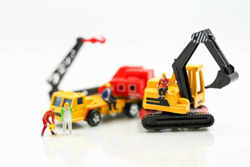 Miniature people : Group of worker and Engineer in a construction site with digger Tractor