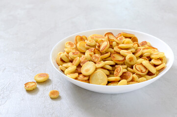 Pancake cereal in a bowl on a light background. Tasty and trendy breakfast. Organic Dutch Mini-Pancakes. Foods trend.