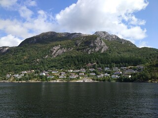 Fototapeta na wymiar Beautiful coastline with norwegian houses and mountains in Stavanger, Norway. 