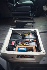 Battery build into the front seat of a camper van