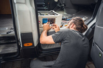 Man working on his camper van conversion © photoschmidt