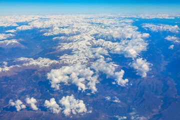 Naklejka premium clouds and snowy mountains panorama