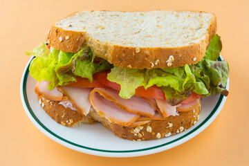 Sandwich of tomato, lettuce and smoked turkey