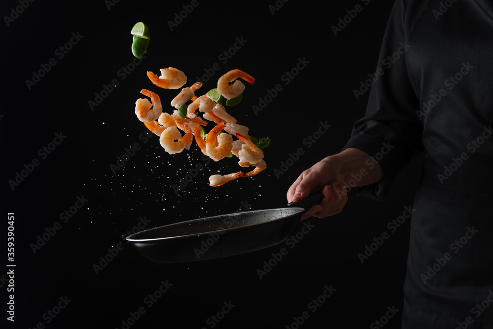 Wall mural fried shrimp with lime in a pan, frozen in motion, asian food - Wall murals
