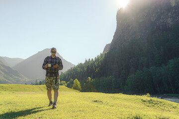 hiker men using smart phone in the mountains