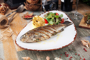 Grilled trout fish with salad and lemon