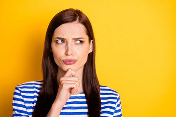 Portrait of unsure girl touch finger chin look copyspace think thoughts try decide decision choose choice wear striped clothes isolated shine color background