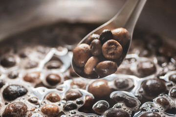 Close up of boiled Thai puff ball mushroom in a spoon, Northern Thai food