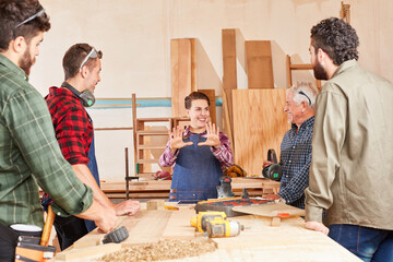 Craftsman team and young woman in teaching