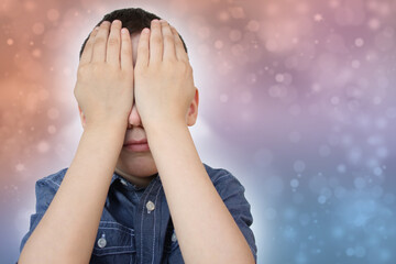 crying child, kid, covering his eyes with fear, shame or resentment, cry and afraid, concept of abuse, outsider in the children’s team, bullying, family violence