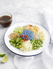 Thai blue rice salad on white marble background. Southern Thai food.