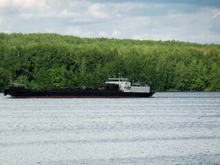 Barge & pusher tug boat on river. Vessel cargo tugboat barge transporting iron, coal to harbor for...