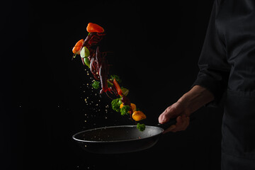 Cooking seafood, frying in a pan with vegetables, veggie healthy food, on a black background, menu and restaurant business
