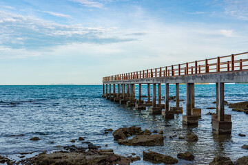 concrete bridge on the island of Koh Samui in Thailand at low tide, pier for mooring ships,...