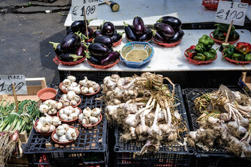 Garlic and eggplants on a market on Carlo Alberto square in Catania city on east coast of Sicily,...