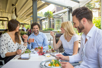 Group of friends having lunch in the restaurant