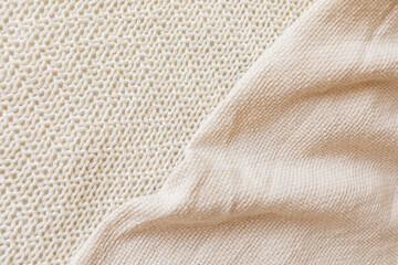 Two soft beige knitted blankets lying diagonally with copy space. Retro abstract boho scandinavian...