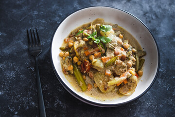 plant-based food, vegan chickpeas stew with carrots onion and broccoli in creamy dairy-free sauce