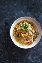 plant-based food, vegan chickpeas stew with carrots onion and broccoli in creamy dairy-free sauce