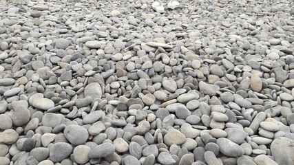 sea beach was completely covered with large stones and pebbles