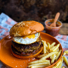Hamburger with Fried Egg with French Fries and Chutney