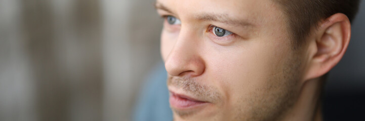 Close-up portrait in profile of an ordinary guy. Appearance young man. Man looks into distance. Calm and satisfaction with life. Positive emotions from loneliness during self-isolation