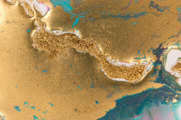 Obraz premium Golden glitter scattering background. Sparkling gold and blue texture.