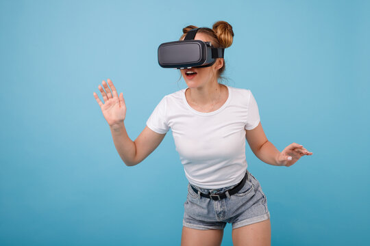 girl in viar glasses, virtual reality glasses on a blue background