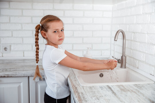 child washing hands with soap and water. hygiene of the child.
