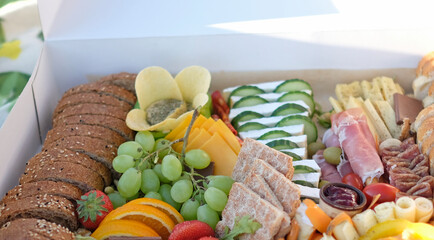 Delicious and inviting picnic box filled with a variety of finger food