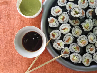 sushi on a plate with chopsticks