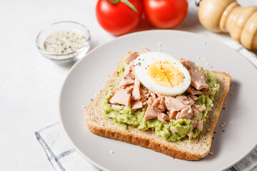 Fototapeta na wymiar Avocado toast with tuna and boiled egg.