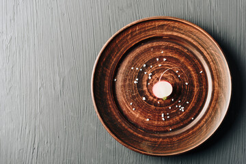 red radish on a plate on a dark background