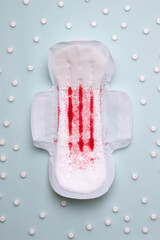 Obraz premium PMS pain treatment concept. pad next to pills