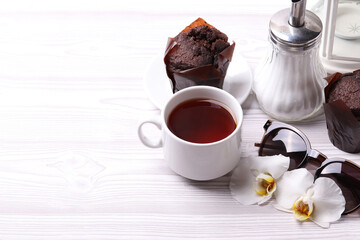 delicious brown chocolate muffin cakes on the white rustic wooden surface. close up. minimalism style