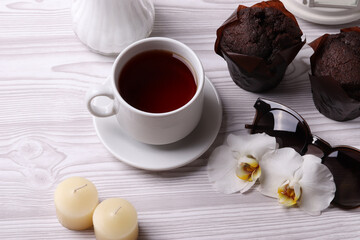 delicious brown chocolate muffin cakes on the white rustic wooden surface. close up. minimalism style