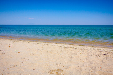 View on the calm sea water and sandy beach