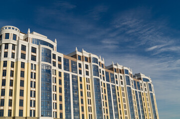 Multi-storey residential buildings against the blue sky in clear weather