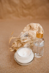 Caring cosmetics in an oyster shell on the sand. Eco-friendly organic cosmetics.