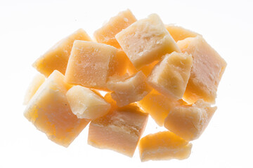 Parmesan cheese cubes isolated on white background.