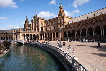 Obraz na płótnie Canvas Seville, Spain - October 20, 2019: Tourists Sightseeing Around Plaza De Espana In Seville, Spain At Sunny Day. Amazing Architecture.
