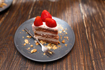 Sweet cakes with summer berries on a wooden table. Party, sweet table. Summer offer desserts in the restaurant.