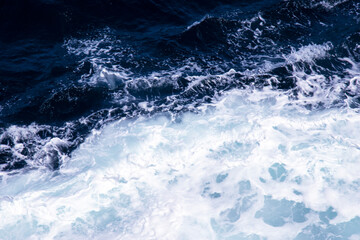 Deep blue sea water with splash and foam. Aerial view to sea waves. Blue water background
