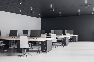 Minimalistic coworking office room with personal computers on table.