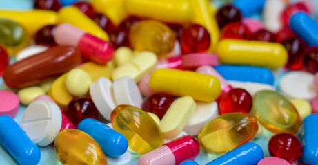 Multi-colored tablets, capsules, vitamins, supplements. ?oncept of treatment and healthcare.