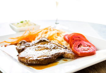 Fried pork steak in plate  , in door  Chiangmai  Thailand