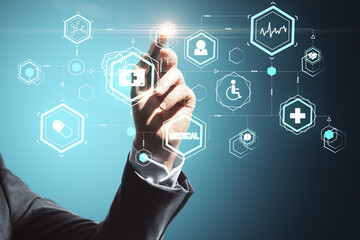 Hand with pen drawing glowing blue medical interface