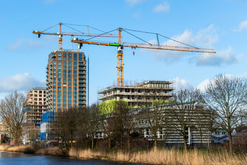 Fototapeta premium Large housing construction project with large cranes in Amersfoort, Netherlands 