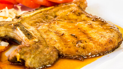 Fried pork steak in plate  , in door  Chiangmai  Thailand