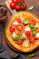 Tasty homemade pizza with tomatoes and basil